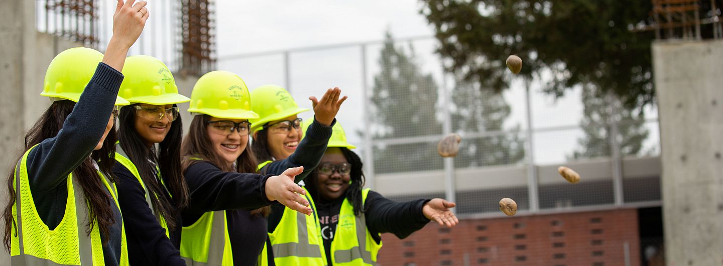 Students throwing blessed stones onto the Jean Hofmann STEM Innovation Center construction site at Carondelet High School in Concord, Cal...