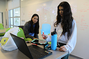 Mariella Cajina '24 and Ananda Jallepalli '26 put the final touches on their pitch presentation for the 2023 Teen Hackathon.