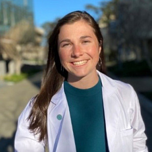 Emily Beck smiles in a lab coat