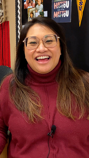 Kay Dinglasan smiles in her Religion classroom