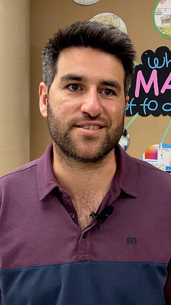 Brad Guslani smiles in his math classroom