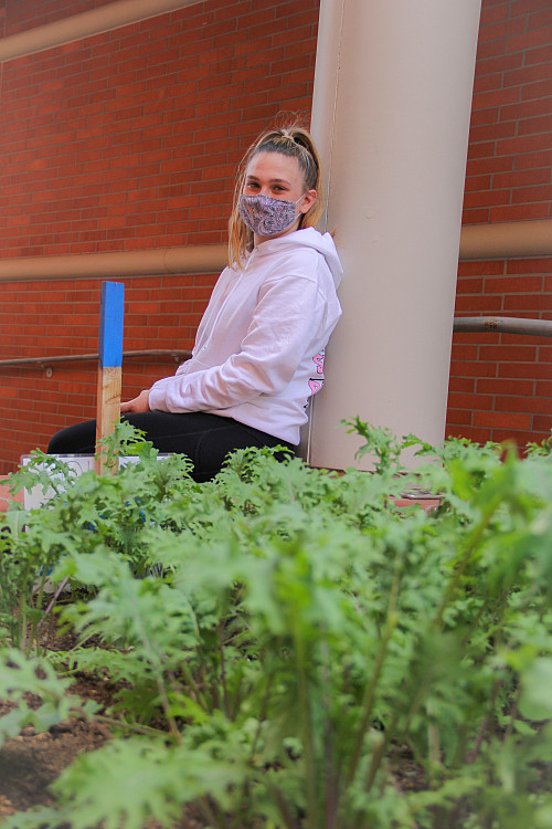 President of Green Team, Chloe D. '22 explains how often Green Team harvests while outside near a...