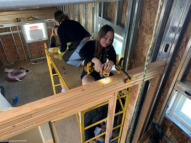Students working inside the tiny house