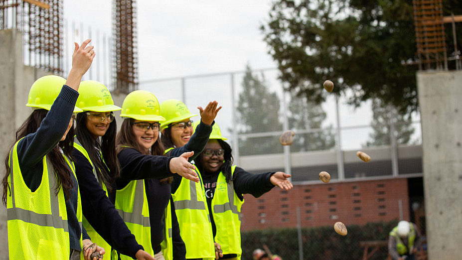 Students throwing blessed stones onto the Jean Hofmann STEM Innovation Center construction site at Carondelet High School in Concord, Cal...