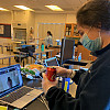 AP Chemistry students conduct a calorimetry lab with their partners at home.