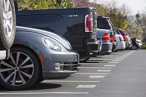 Cars lined up in a full parking lot